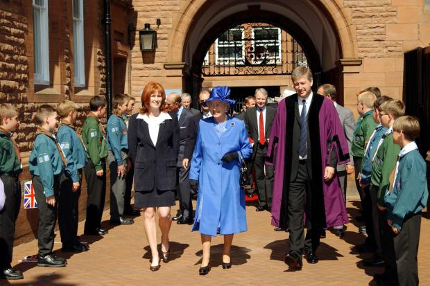 ROYAL VISIT: The Queen passes through a guard of honour laid on by local scout groups at Carlisle’s Tullie House with Joanne Orr and Mike Mitchelson in 2002 during her Golden Jubilee year visit to the county