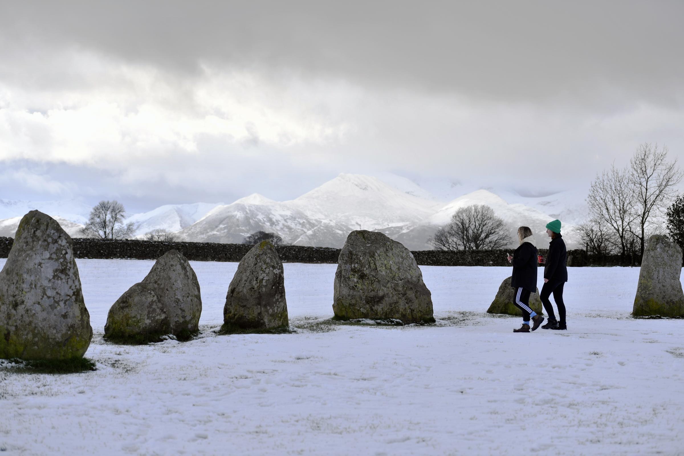 A light covering of snow across the high ground of Cumbria and the Lake District Fells. Visitors to Castlerigg Stone Circle near Keswick enjoy the winter scenes: 22 January 2019..STUART WALKER.
