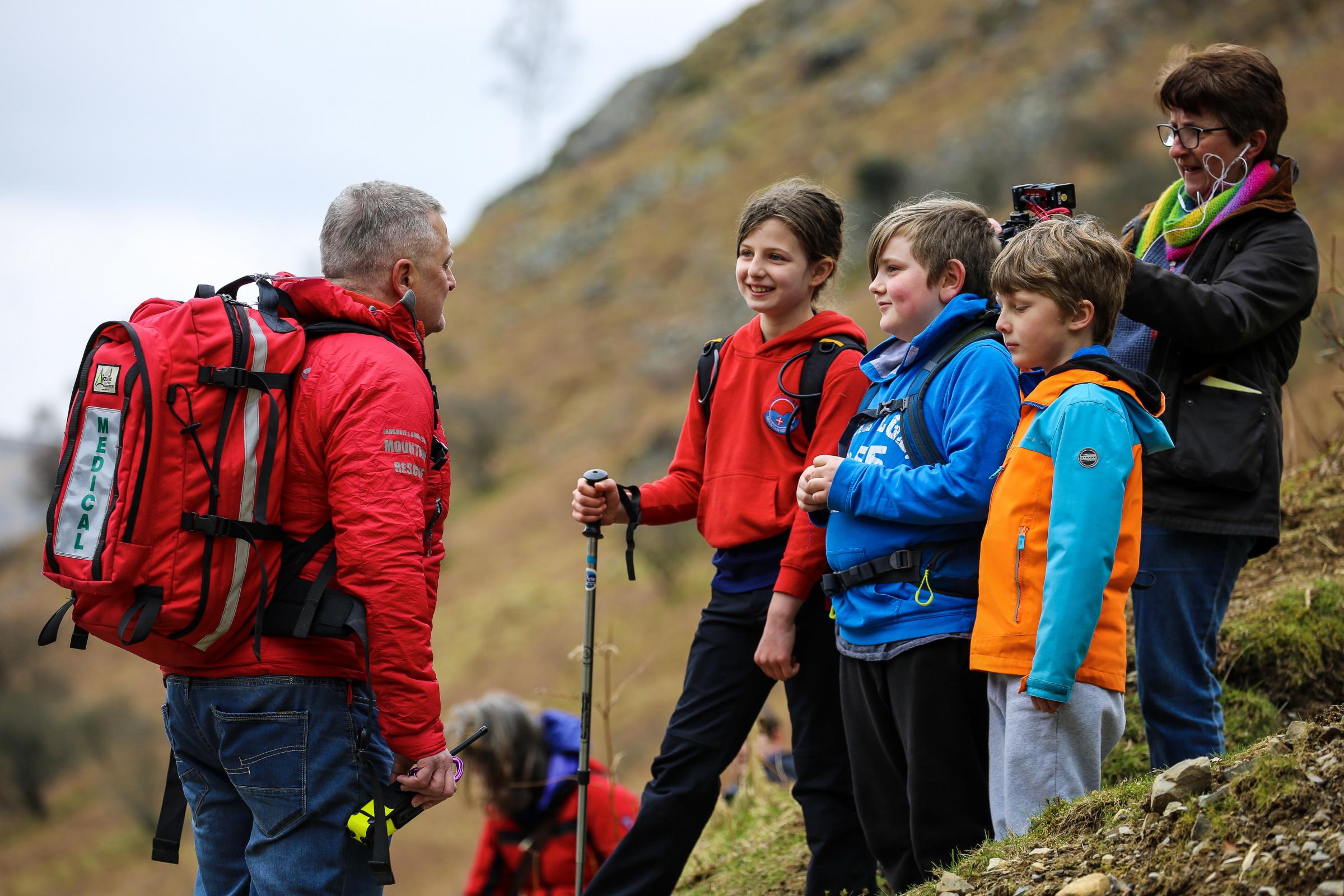 MESSAGE: The children filming with Nick Owen, of Langdale/Ambleside Mountain Rescue Team. Picture: Jonathan Smith, Grasmere School