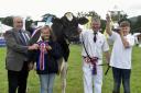 Penrith Agricultural Show 2019, at Brougham Hall Farm, near Penrith, 20 July 2019...Pictured are John Harrison, from Crossrigg Farm, Cliburn, and children Molly, aged 12, and Thomas aged 13, with their Holstien which took show Champion of Champions and