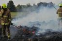 Firefighters attend a blaze after a stack of hay bales were set alight.