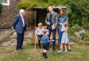 The Duke and Duchess of Cambridge, Prince George (seated), Princess Charlotte and Prince Louis with Sir David Attenborough in the gardens of Kensington Palace after the Duke and Sir David attended an outdoor screening of Sir David's upcoming feature f