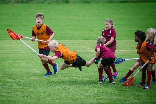 Cumberland & Westmorland Gazette: COMPETITION: Pupils playing sports on the field