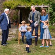The Duke and Duchess of Cambridge, Prince George (seated), Princess Charlotte and Prince Louis with Sir David Attenborough in the gardens of Kensington Palace after the Duke and Sir David attended an outdoor screening of Sir David's upcoming feature f